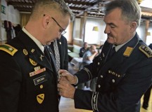 Oberstabsfeldwebel Roland Christmann (right), a senior NCO from a local German reserve organization, pins a commendation medal on Lt. Col. George Brown, U.S. Army Garrison Rheinland-Pfalz’s emergency services director.