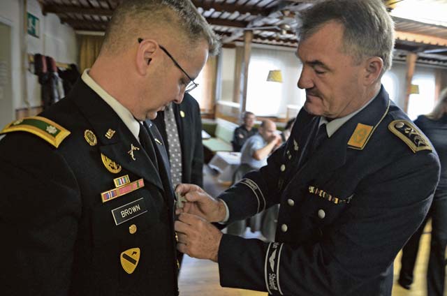Oberstabsfeldwebel Roland Christmann (right), a senior NCO from a local German reserve organization, pins a commendation medal on Lt. Col. George Brown, U.S. Army Garrison Rheinland-Pfalz’s emergency services director. 