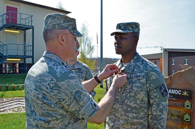 Photos by Staff Sgt. John Zumer U.S. Army 1st Sgt. Gary Threets, 11th Missile Defense Detachment, 10th Army Air and Missile Defense Command, receives the Air Force Commendation Medal from U.S. Air Force Lt. Gen. Craig Franklin, 3rd Air Force commander, April 24 on Ramstein. The Rhine Ordnance Barracks ceremony recognized Threets for his distinguished service rendered on Turkey-based operations of the 10th AAMDC.