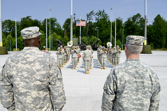 Col. Gregory Brady, incoming commander of the 10th Army Air and Missile Defense Command, stands with Command Sgt. Maj. Harold Lincoln, the 10th AAMDC command sergeant major, as they observe a U.S. Army Europe band during a change of command ceremony July 10 at Rhine Ordnance Barracks. The event marked the beginning of Brady’s slated two year assignment as commander of the 10th AAMDC and featured the passing of leadership responsibilities to Brady by outgoing commander Col. Stephen Richmond. 