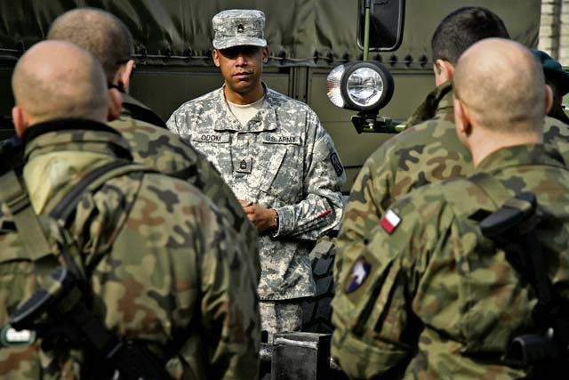 U.S. Army Sgt. 1st Class Charles Odom from the 16th Sustainment Brigade conducts a class on vehicle shipment preparation and U.S. customs inspections to prepare soldiers from the Polish Land Forces 10th Logistics Brigade for their deployment to Afghanistan.
