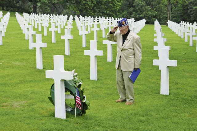 World War II veteran Pfc. Leslie Cruise salutes the gravesite of Pfc. Richard Vargas during a wreath laying ceremony June 2 at the Lorraine American Cemetery and Memorial.