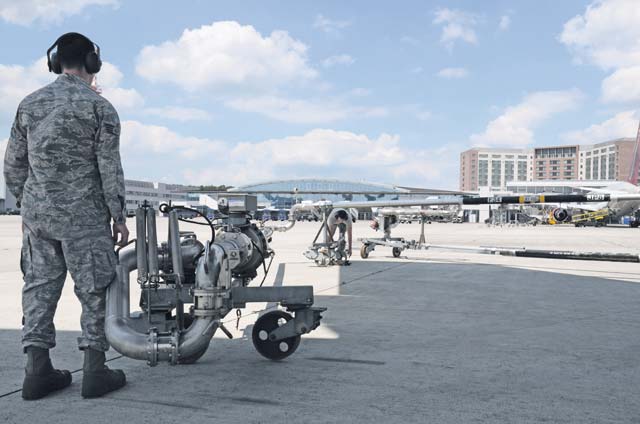 Photo by Senior Airman Timothy MooreStaff Sgt. Michael Mandelbaum, 86th Logistics Readiness Squadron fuels distribution  operator, moves a fueling pantograph into place in preparation for refueling an incoming aircraft. 