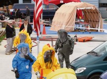 Sgt. Erick Galkowski (in blue), a chemical, biological, radiological and nuclear survey team member with the 773rd Civil Support Team, 7th Civil Support Command, assists Belgian firefighters in mitigating and containing a mock chemical spill during a joint exercise June 2 to 8.