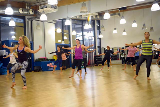 During De-Stress Day at the Ramstein Southside Fitness Center, fitness teacher Teresa Romanowicz shows class participants how to dance to various types of music to de-stress in a healthy way before the busy holiday season.