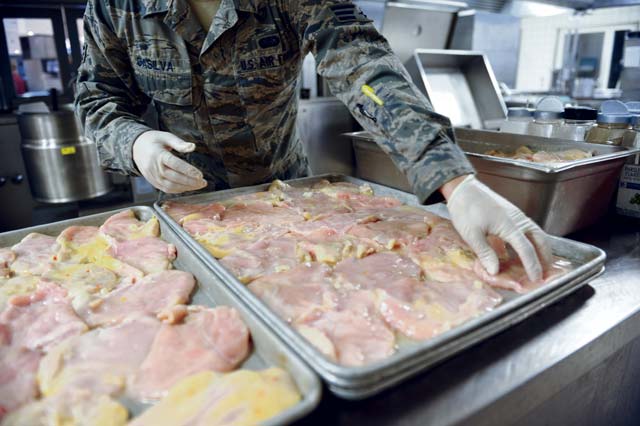 Senior Airman Jonathan DaSilva, 786th Force Support Squadron food service journeyman, prepares chicken breasts for lunch Oct. 8 in the Rhineland Inn Dining Facility on Ramstein. The Rhineland Inn Dining Facility offers four meals a day, providing Airmen a full-service main line, snack line and sandwich bar.