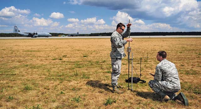 Master Sgt. Stanley MacDonald, 435th AGOW’s AMS air traffic controller, and Staff Sgt. Brock Neel, 435th AMS engineer, survey an area for training with a dynamic cone penetrometer July 11 at Powidz Air Base, Poland. The measure- ment from the DCP is one of the steps in determining if an airfield is safe for an aircraft landing.