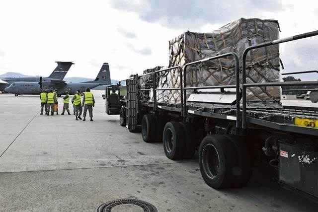 Mobility assets are transported to a C-130 Hercules during an engine-running onload. Airmen from the 721st Aerial Port Squadron and 37th Airlift Squadron trained together in a non-hostile environment to be better prepared when deployed.