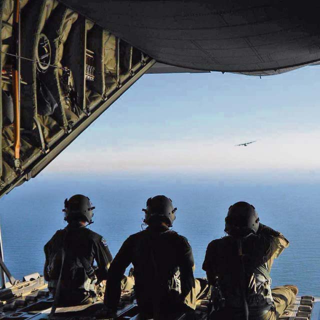 Courtesy photo(From left) Staff Sgt. Matthew Merkley, Senior Airman Nicholas Cunningham and Staff Sgt. Michael Demik,  37th Airlift Squadron loadmasters, look out of the back of a C-130J Super Hercules during a training  mission.