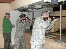 Martin Andres (left) of the Baumholder shooting club supervises American guests Staff Sgt. April Tessmer and Lt. Col. John Broomhead as they shoot with small caliber rifles on the 50-meter range at the shooting clubhouse in Baumholder.