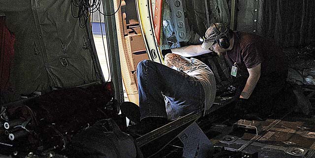 Photos by Airman 1st Class Holly MansfieldZach Edens (left) and Joel Rykard, 560th Aircraft Maintenance Squadron mechanics from Robbins Air Force Base, Ga., prepare a C-130J Super Hercules to be compatible for a new seat as part of the Time Compliance Technical Order configuration April 4 on Ramstein. The new seat will enable loadmasters to have an approved seat for takeoffs and landings and will increase their survivability in the event of a hard landing or crash. It will also allow the loadmaster to safely scan for surface-to-air weapons while in flight.