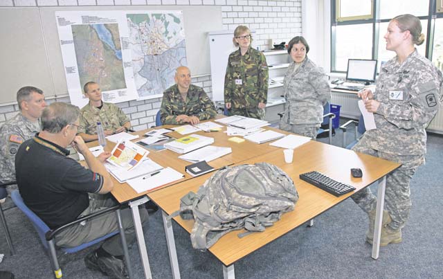 U.S. Army Sgt. 1st Class Maria Pitrone (right), D Company, 457th Civil Affairs Battalion, 361st Civil Affairs Brigade, 7th Civil Support Command training NCO, guides her students as their syndicate coach during the NATO-accredited Civil-Military Cooperation Centre of Excellence CIMIC field worker course Sept. 23.