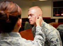 Airman 1st Class Joanne Collantes, 86th Medical Support Squadron medical materiel technician, applies makeup to Airman 1st Class Austin Hennessee, 86th Communications Squadron cyber infrastructure technician, before participating in the “Thank You for Asking” social experiment Oct. 23 on Ramstein.