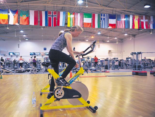 PT Boot Camp attendee Loriann Tierney pedals on a stationary bicycle during a PT Boot Camp class Nov. 7 on Ramstein.