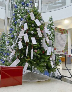 A tree, sign and donation collection box for the 2014 Angel Tree program sit in the middle of the Kaiserslautern Military Community Center Nov. 17 on Ramstein.