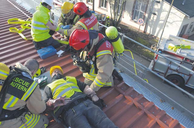 U.S. Army Garrison Rheinland-Pfalz firefighters treat simluated casualties on a rooftop at Kleber Kaserne in Kaiserslautern.