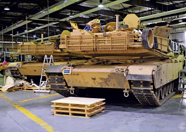 Two tanks from 1st Brigade Combat Team, 1st Cavalry Division sit in a maintenance bay for cleaning and retrograde maintenance Dec. 11 at Kaiserslautern Army Depot. These tanks will return to the United States after use in the Baltic region of Europe during Operation Atlantic Resolve.