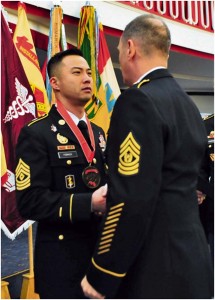 Photo by Sgt. 1st Class Alexander A. BurnettCommand Sgt. Maj. David Davenport Sr. (right), U.S. Army Europe command sergeant major, presents 1st Sgt. Anthony Forker Jr., Headquarters and Headquarters Company, 30th Medical Brigade first sergeant, with his Sergeant Morales Club medallion during an induction ceremony Jan. 7 at Armstrong’s Club on Vogelweh.