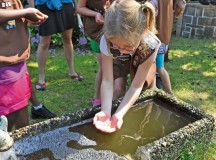 USA Girl Scouts Overseas play in the water during their field trip to the water treatment facility June 13 on Ramstein. The 786th Civil Engineer Squadron tests and purifies the drinking water for the KMC to ensure the distributed water is consumable for Airmen and civilians on base.
