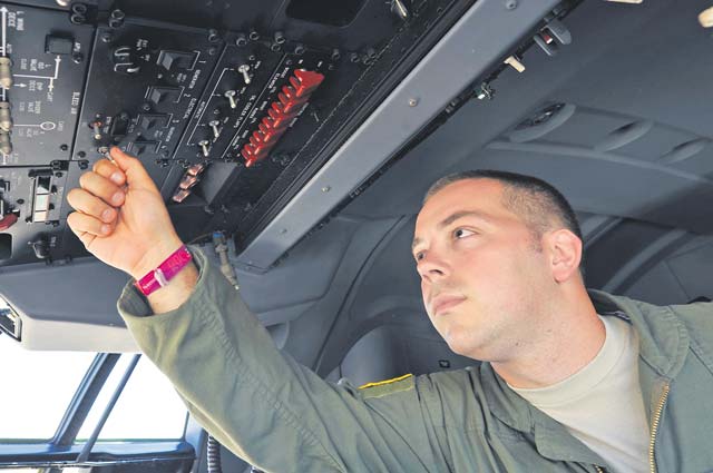Senior Airman Nicholas Cunningham, 37th Airlift Wing loadmaster, conducts a pre-flight inspection on a C-130 Hercules.