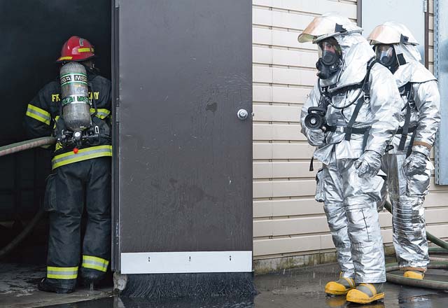 Firefighters from the 86th Civil Engineer Squadron wait for their cue to enter the burn house for Silver Flag training. The CES firefighters participated in the event to practice putting out fires in the burn house and simulated aircraft.
