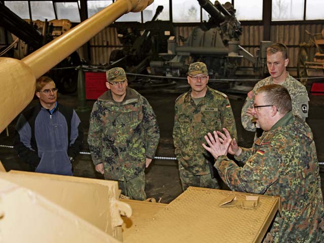From left, Sgt. 1st Class Carlos Diaz, communications NCOIC, 457th Civil Affairs Battalion, 361st Civil Affairs Brigade, 7th Civil Support Command; German air force Senior Master Sgt. Jochen Werner, German military senior enlisted liaison with the 21st Theater Sustainment Command; German Lt. Col. Thies Neelsen, German Army Logistic Command liaison officer at the 21st TSC; and Staff Sgt. Walter Egan, motor sergeant, Headquarters and Headquarters Company, 361st Civil Affairs Brigade listen to German army Lt. Col. Lars Kleine, commanding officer of the foreign language training section at the German Artillery School during a tour of the German Army artillery museum Nov. 14.