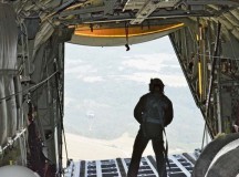 Photo by Sgt. Daniel WyattAn Airman with the 37th Airlift Squadron observes an air-dropped cargo pallet from the back of a C-130J