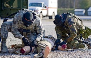 Tech. Sgt. Jarvis Thompson (left), 703rd Munitions Support Squadron NCOIC of police services on Volkel Air Base in the Netherlands, and Master Sgt. Christoph Czaja, German air force security forces squadron member, pull a simulated casualty away from the oppositional forces line of fire.