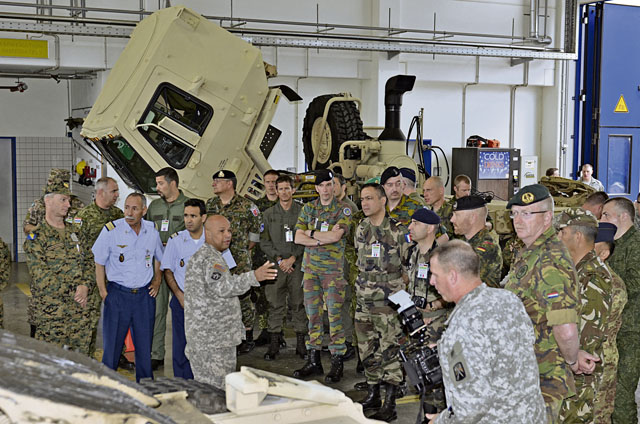 Master Sgt. Wilfredo Rivera, 317th Maintenance Support Company, explains to 33 delegates from Conventional Forces Europe Treaty Compliance countries, who visited Baumholder June 26, what Soldiers do on a day-to-day basis in a motor pool. The delegates also received information  from U.S. Army Garrison Baumholder personnel about how Soldiers, family members and civilians live, work and play on a U.S. military installation.