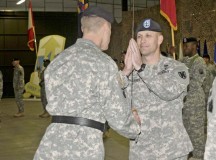 Maj. Gen. John R. O’Connor, commanding general of the 21st Theater Sustainment Command, hands the noncommissioned officer sword to Command Sgt. Maj. Rodney J. Rhoades, the incoming command sergeant major of the 21st TSC, during a change of responsibility ceremony Dec. 19 on Rhine Ordnance Barracks.