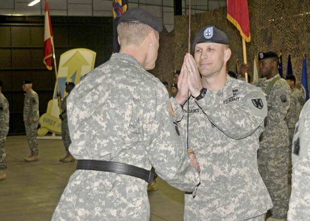 Maj. Gen. John R. O’Connor, commanding general of the 21st Theater Sustainment Command, hands the noncommissioned officer sword to Command Sgt. Maj. Rodney J. Rhoades, the incoming command sergeant major of the 21st TSC, during a change of responsibility ceremony Dec. 19 on Rhine Ordnance Barracks.