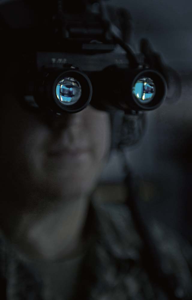 Staff Sgt. Anthony Gentry, 86th Operations Support Squadron aircrew flight equipment, secures a pair of night vision goggles to a helmet Jan. 14 on Ramstein. Airmen with the aircrew flight equipment section are responsible for ensuring mission-critical equipment is in working condition.