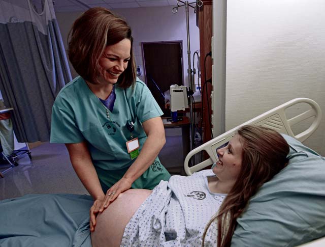 Capt. Syrah Nicaisse, 86th Medical Squadron certified nurse midwife, assists Laurenne LoVullo before she goes into labor Feb. 28 at Landstuhl Regional Medical Center. As a certified nurse midwife, Nicaisse is medically trained to provide health care to women throughout their pregnancies and after delivery.