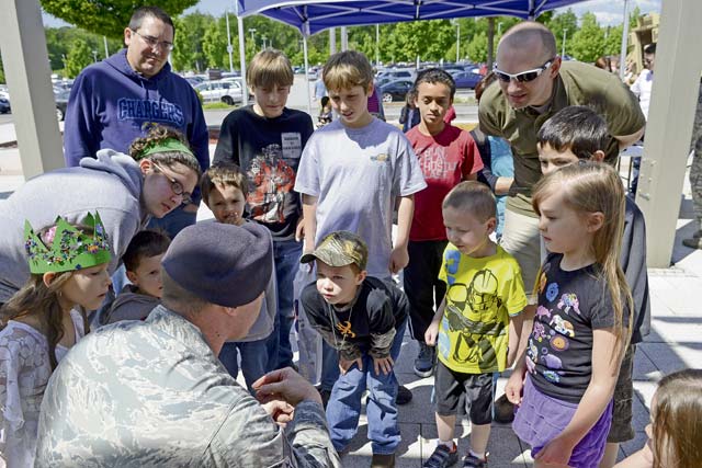 Staff Sgt. Jeffery Fitzgerald, 86th Security Forces Squadron training instructor, shows the barb from a training Taser cartridge to a crowd during the 86th SFS Police Week display May 17 on Ramstein. The event occurred during National Police Week and was held to provide community involvement and safety tips. The 86th SFS assembled the displays and demonstrations to provide community members the opportunity to gain first-hand knowledge of what security forces does on Ramstein.  The 86th SFS also gave lethal and less-than-lethal weapon safety tips while providing community involvement.