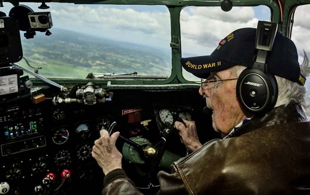Bill Prindible, a veteran U.S. Army pilot who flew on D-Day, takes the controls of a C-47 Skytrain during a flight over Normandy June 5. Prindible was visiting Normandy as part of the 70th anniversary of the invasion of Normandy. More than 60 Ramstein Airmen traveled to Normandy to honor the sacrifices made by veterans of World War II.
