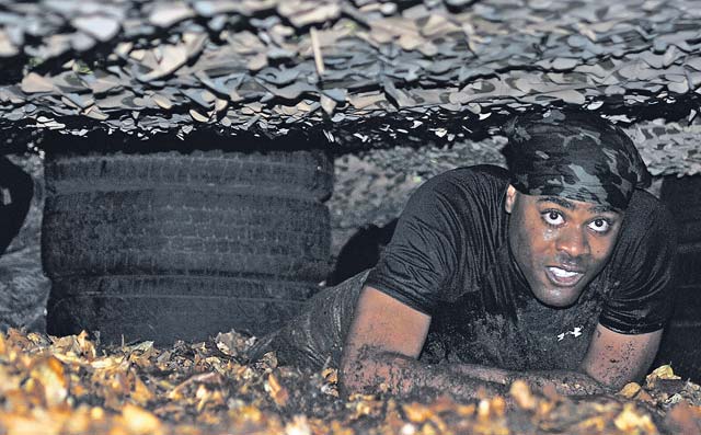 A Mudless Mudder participant low-crawls through a muddy obstacle June 19 on Ramstein. The 86th Airlift Wing hosted Resiliency Day to give members an opportunity to strengthen team building.