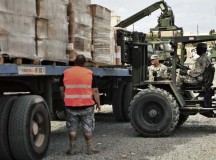 Photos by Sgt. 1st Class Alexander BurnettNoncommissioned officers assigned to the 21st Theater Sustainment Command’s Regional Support Element-United Assistance help contractors download pallets of food and supplies for the Intermediate Staging Area Nov. 22 in Dakar, Senegal.