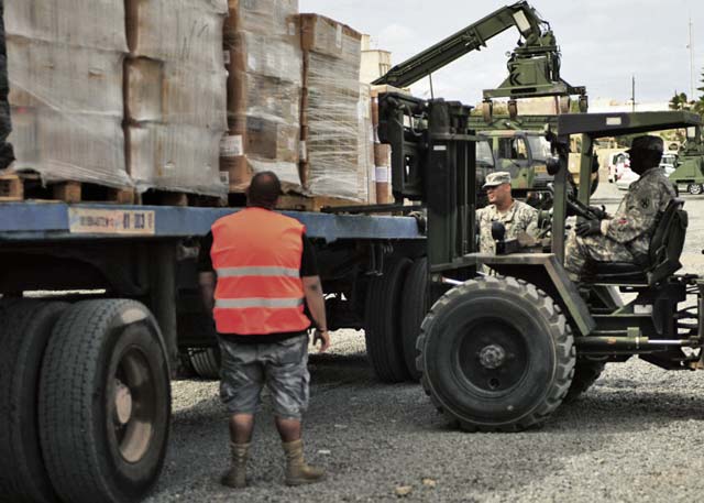 Photos by Sgt. 1st Class Alexander BurnettNoncommissioned officers assigned to the 21st Theater Sustainment Command’s Regional Support Element-United Assistance help contractors download pallets of food and supplies for the Intermediate Staging Area Nov. 22 in Dakar, Senegal.