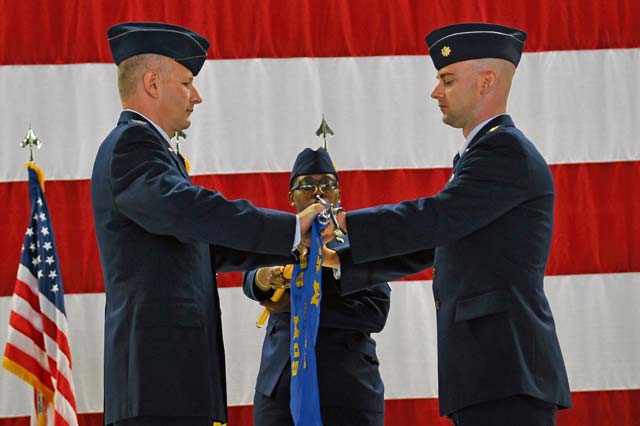 Col. Raymond Briggs (left), 86th Maintenance Group commander, and Maj. Mark Ashman, 86th Maintenance Operations Squadron, furl the squadron flag during the 86th MOS inactivation ceremony July 1 on Ramstein.