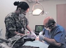 Sgt. 1st Class Randall JacksonSpc. Rosa Reilvitz (left), an oral surgery assistant, and Col. (Dr.) Tamer Goksel, an oral surgeon from the Landstuhl Oral Surgery Clinic, provide dental treatment to a local Army retiree Oct. 26 at the Pulaski Dental Clinic. The clinic treated nearly 100 military retirees and spouses during the joint Army and Air Force sponsored event that was part of the recent Retiree Appreciation Day.