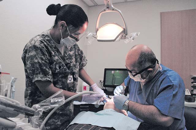 Sgt. 1st Class Randall JacksonSpc. Rosa Reilvitz (left), an oral surgery assistant, and Col. (Dr.) Tamer Goksel, an oral surgeon from the Landstuhl Oral Surgery Clinic, provide dental treatment to a local Army retiree Oct. 26 at the Pulaski Dental Clinic. The clinic treated nearly 100 military retirees and spouses during the joint Army and Air Force sponsored event that was part of the recent Retiree Appreciation Day.