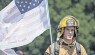 Airman 1st Class William Campbell, 86th Civil Engineer firefighter, carries a commemorative 9/11 flag during the Viking Challenge.