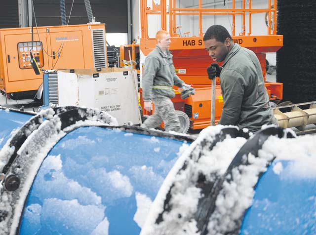 Airman 1st Class Pascal Dieujuste, 786th Civil Engineer Squadron heavy equipment operator, cleans off a plow after the shop cleared the first snow of the season from the flightline Dec. 3. Dieujuste and a team of Airmen started early in the morning to ensure Ramstein could keep launching aircraft.