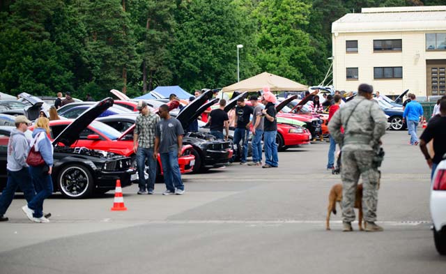 Airmen and families look at vehicles at the 8th Annual Vehicle Readiness Squadron Car Show  Aug. 16 on Ramstein. More than 200 vehicles participated in this year’s car show, making it the largest to date. 