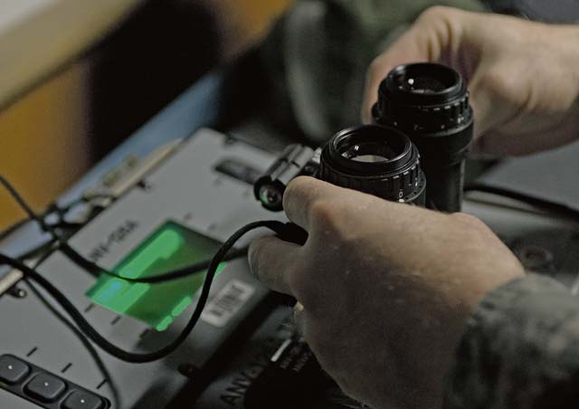 Staff Sgt. Anthony Gentry, 86th Operations Support Squadron aircrew flight equipment, connects a pair of night vision goggles to a calibration device Jan. 14 on Ramstein. 