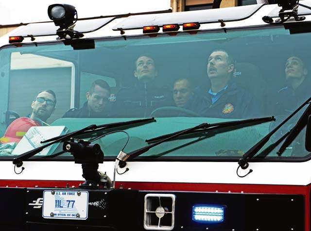 Bundeswehr firefighters check for safety switches as they familiarize themselves with base fire trucks.