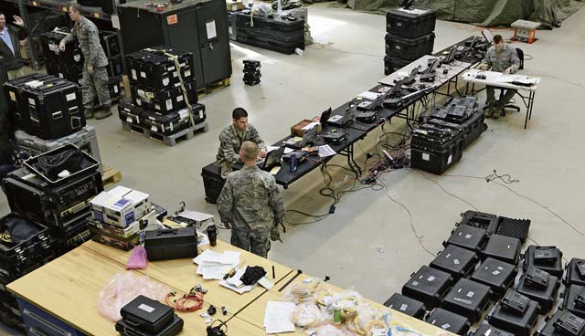 Airmen from the 1st Combat Communications Squadron repair connection equipment to  provide communications support to the KMC March 3 on Ramstein.