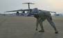 Senior Master Sgt. Joseph Wheeler, 721st Aerial Port Squadron first sergeant, picks up trash from the flightline during a foreign object damage prevention walk.
