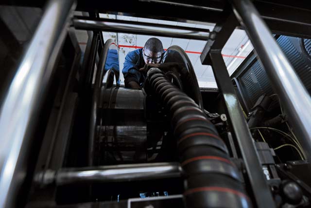 Senior Airman David Grandison, 86th Vehicle Readiness Squadron refueling maintenance technician, performs maintenance on a refueling unit-hose reel. 