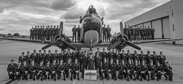 Photo illustration by Airman 1st Class Jordan CastelanMembers of the 37th Airlift Squadron gather for a group photo in front of a Douglas C-47 Skytrain, designated Whiskey 7, May 29, 2014, on Ramstein. The 37th AS recreated the historical photo to mimic a photo taken 70-years ago of the exact same aircraft with members of the 37th Troop Carrier Squadron. 